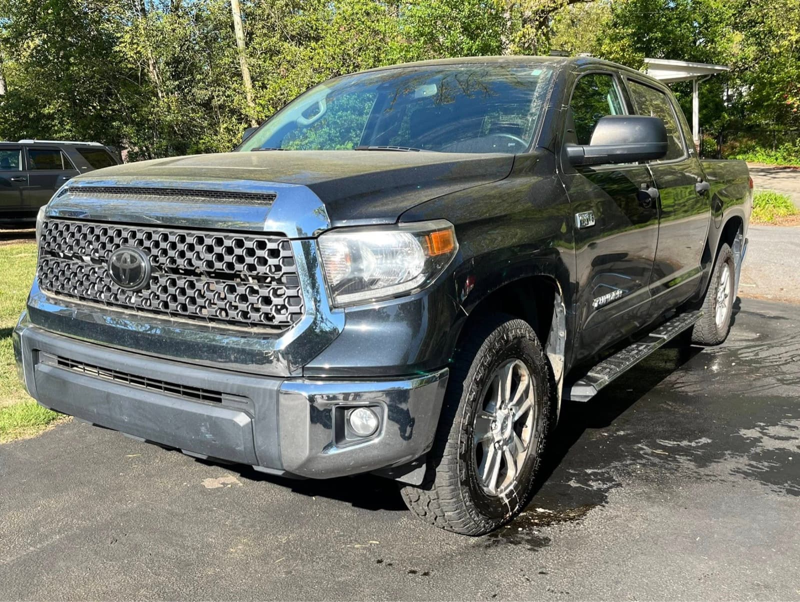 Toyota Tundra exterior before mobile detailing — water spots and dust on dark paint